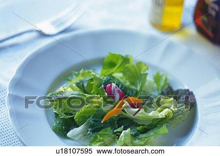 Mixed salad leaves on plate, two bottles and fork visible in background, Differential Focus View Large Photo Image Stock Photography - Mixed salad leaves on plate, two bottles and fork visible in background, Differential Focus. Fotosearch