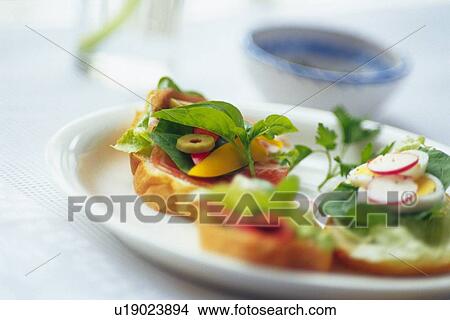 Mixed salad on baguette, cup visible in background, Differential Focus View Large Photo Image Picture - Mixed salad on baguette, cup visible in background, Differential Focus. Fotosearch