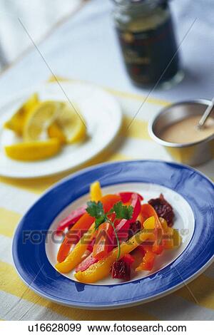 Stock Photo - Paprika slices on plate, other plate visible in background, Differential Focus. Fotosearch