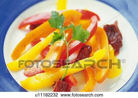 Stock Image - Pickled paprika slices on plate, Differential Focus. Fotosearch