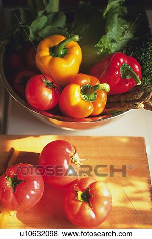 Tomatoes on cutting board, paprika on bowl, Differential Focus View Large Photo Image Stock Photo - Tomatoes on cutting board, paprika on bowl, Differential Focus. Fotosearch
