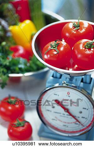 Tomatoes on kitchen weighing scales, various vegetables in bowl visible in background, Differential Focus View Large Photo Image Stock Image - Tomatoes on kitchen weighing scales, various vegetables in bowl visible in background, Differential Focus. Fotosearch