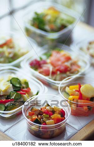 Stock Image - Various salad in plastic cases, Differential Focus. Fotosearch