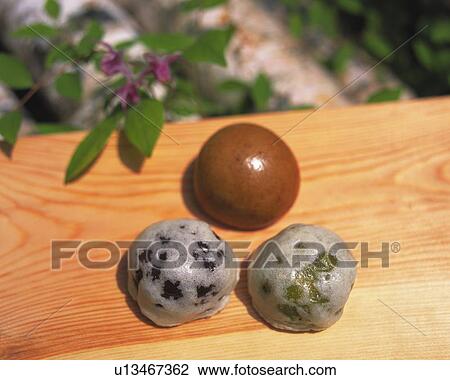Stock Image - Manjyu, Japanese sweets on wooden board, high angle view, Differential Focus. Fotosearch