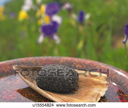 shi called Gomaohagi, Japanese sweet on bamboo plate, flower visible in background, Differential Focus View Large Photo Image Picture - shi called Gomaohagi, Japanese sweet on bamboo plate, flower visible in background, Differential Focus. Fotosearch