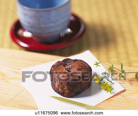 Stock Photograph - shi called Kintsuba on Japanese papers, cup visible in background, Differential Focus. Fotosearch