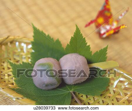Stock Image - shi called Kusadango, Japanese sweets on leaf, crane visible in background, Differential Focus. Fotosearch