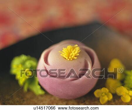 Stock Photograph - shi, Japanese sweet and flower heads on plate, Differential Focus, Close Up. Fotosearch
