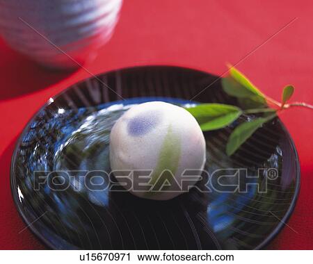 Stock Image - shi, Japanese sweet on plate, cup visible in background, Differential Focus. Fotosearch