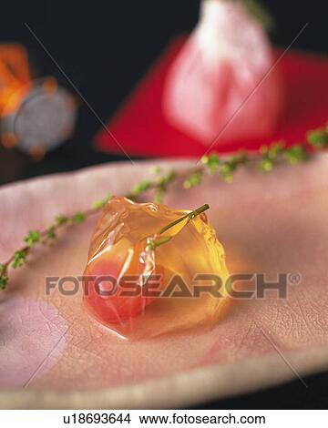 Picture - shi, Japanese sweet plate, another shi and toy of hand drum visible in background, high angle view, Differential Focus. Fotosearch