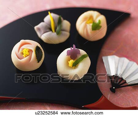 Picture - shi, Japanese sweets on fan, small fan beside, high angle view, Differential Focus. Fotosearch
