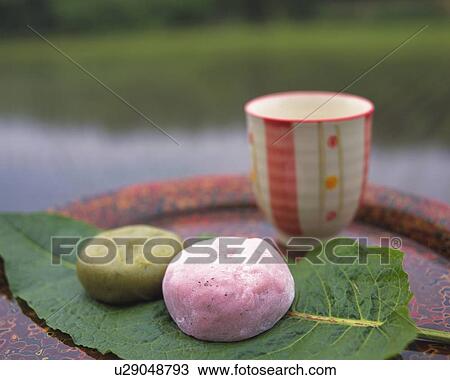 Stock Image - shi, two types of Japanese sweets on leaf, Kusamochi and Umedaihuku, high angle view, Differential Focus. Fotosearch