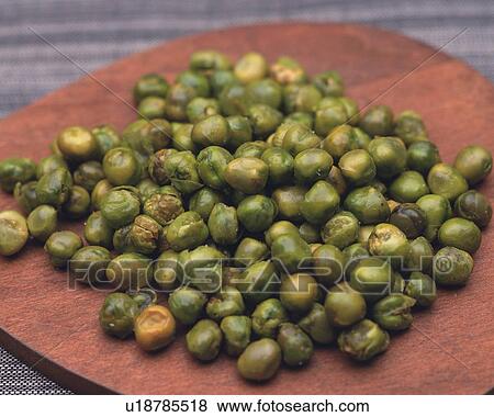 Closed Up Image of a Bunch of Green Peas on a Small Wooden Plate, High Angle View View Large Photo Image Stock Photo - Closed Up Image of a Bunch of Green Peas on a Small Wooden Plate, High Angle View. Fotosearch