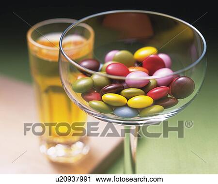 Closed Up Image of a Cocktail Glass Filled With Some Colorful Chocolate Pieces and Some Juice Near It, High Angle View, Differential Focus View Large Photo Image Stock Image - Closed Up Image of a Cocktail Glass Filled With Some Colorful Chocolate Pieces and Some Juice Near It, High Angle View, Differential Focus . Fotosearch