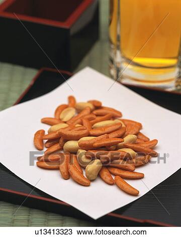 Stock Image - Closed Up Image of a Japanese Snack On a Traditional Japanese Plate, Next to a Glass of Beer, High Angle View, Differential Focus. Fotosearch