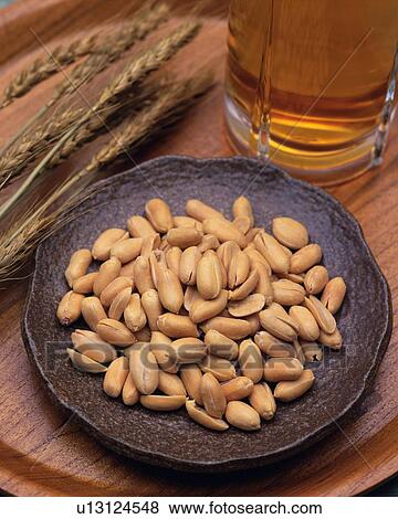 Closed Up Image of a Little Plate Filled With Peanuts and a Beer, High Angle View View Large Photo Image Stock Photo - Closed Up Image of a Little Plate Filled With Peanuts and a Beer, High Angle View. Fotosearch