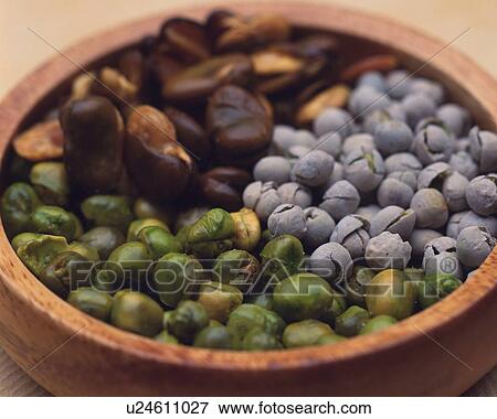 Stock Photo - Closed Up Image of a Little Wooden Bowl Filled With Several Beans and Peas, High Angle View, Differential Focus. Fotosearch