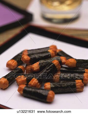 Stock Image - Closed Up Image of a Traditional Japanese Snack, Some Rice Crackers Filled With Dried Seaweed and a Drink, Differential Focus. Fotosearch
