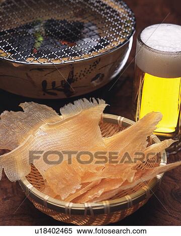 Closed Up Image of a Typical Japanese Snack, Some Dried Fish Next to a Small Grill and a Glass of Beer, High Angle View View Large Photo Image Stock Photography - Closed Up Image of a Typical Japanese Snack, Some Dried Fish Next to a Small Grill and a Glass of Beer, High Angle View. Fotosearch