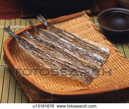 Closed Up Image of Four Pieces of Dried Fish on a Wooden Plate. Next to a Little Cup of Sake, High Angle View View Large Photo Image Stock Photograph - Closed Up Image of Four Pieces of Dried Fish on a Wooden Plate. Next to a Little Cup of Sake, High Angle View. Fotosearch