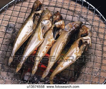 Stock Photo - Closed Up Image of Several Little Fish Being Grilled on a Japanese Grill, High Angle View. Fotosearch
