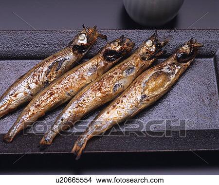 Closed Up Image of Several Little Grilled Fish on a Black-colored Plate, High Angle View View Large Photo Image Picture - Closed Up Image of Several Little Grilled Fish on a Black-colored Plate, High Angle View. Fotosearch