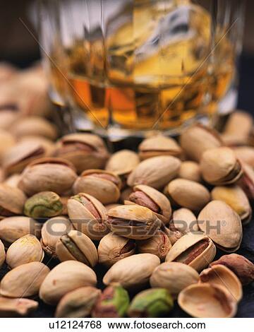 Closed Up Image of Several Pistachios Next to A Glass With Beer, Differential Focus View Large Photo Image Stock Photo - Closed Up Image of Several Pistachios Next to A Glass With Beer, Differential Focus. Fotosearch