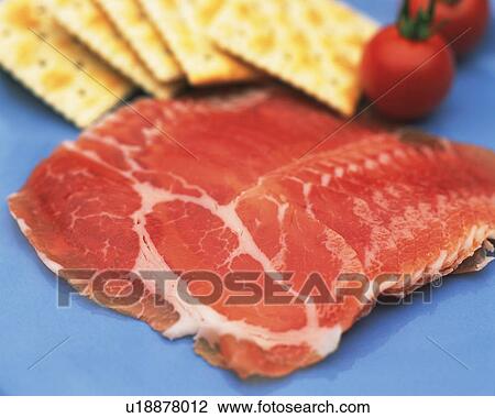 Stock Image - Closed Up Image of Several Slices of Raw Ham and Some Crackers, Differential Focus. Fotosearch