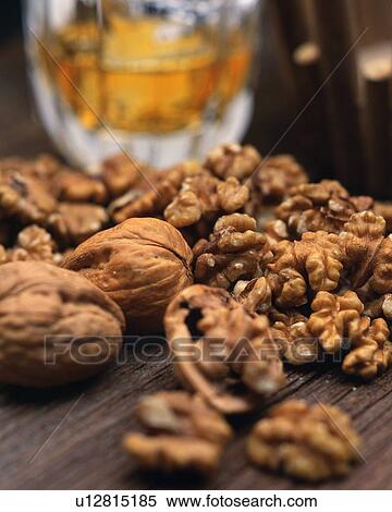 Stock Photography - Closed Up Image of Several Walnuts Next to a Glass of Beer, Differential Focus. Fotosearch