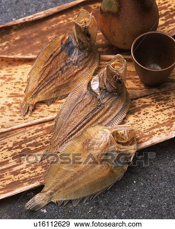 Closed Up Image of Some Dried Fish Lying on Some Wood and Some Sake, High Angle View View Large Photo Image Stock Photo - Closed Up Image of Some Dried Fish Lying on Some Wood and Some Sake, High Angle View. Fotosearch
