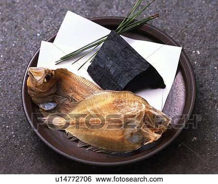 Closed Up Image of Two Dried Flatfish Next to a Piece of Coal on a Plate, High Angle View View Large Photo Image Stock Photograph - Closed Up Image of Two Dried Flatfish Next to a Piece of Coal on a Plate, High Angle View. Fotosearch