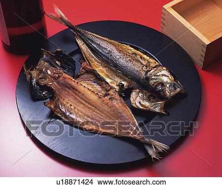 Closed Up Image of Two Pieces of Grilled Fish on a Black Plate, Next to a Wooden Box Filled With Sake, High Angle View View Large Photo Image Picture - Closed Up Image of Two Pieces of Grilled Fish on a Black Plate, Next to a Wooden Box Filled With Sake, High Angle View. Fotosearch