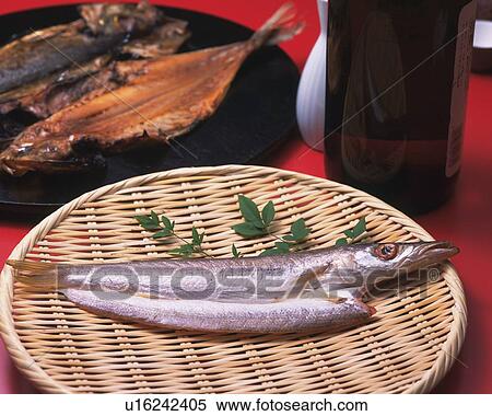 Stock Photography - Image of a Large Fish Decorated With Some Herbs, Lying on a Wooden Plate, High Angle View. Fotosearch