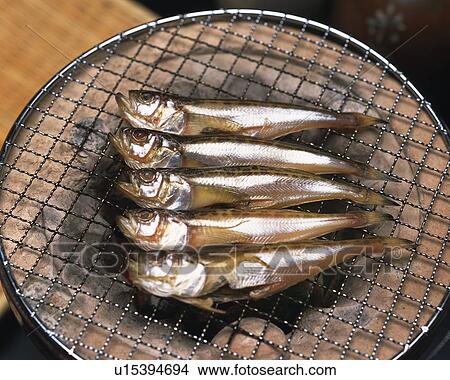 Picture - Image of Several Fish Being Grilled on a Japanese Grill, High Angle View. Fotosearch