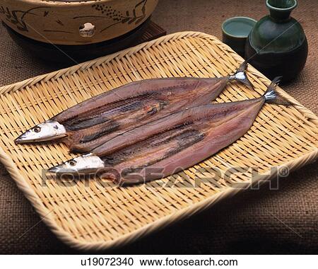 Stock Image - Image of Two Fish, Lying on a Wooden Plate Next to Some Sake, High Angle View. Fotosearch