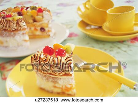 A piece cut of fruitcake and dishes on table View Large Photo Image Stock Photo - A piece cut of fruitcake and dishes on table. Fotosearch