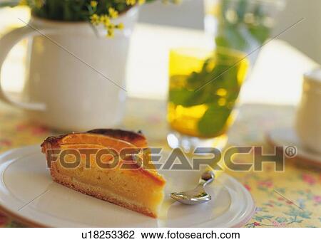 Stock Image - A slice of orange tart on plate. Fotosearch