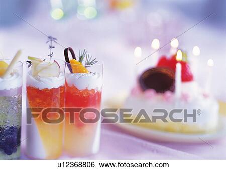 Stock Photograph - Birthday cake and jelly in glasses. Fotosearch