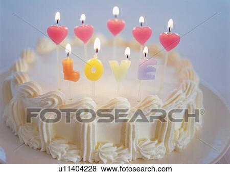 Cake with heart shaped candles and spelling "LOVE" View Large Photo Image Stock Photo - Cake with heart shaped candles and spelling "LOVE". Fotosearch