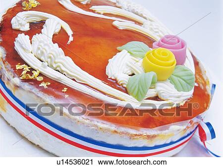 Stock Image - Cheese cake with whipped cream, Wrapped by ribbon. Fotosearch