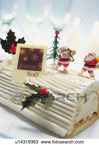 Stock Image - Christmas cake rolled up and covered with cream, Yolu log . Fotosearch