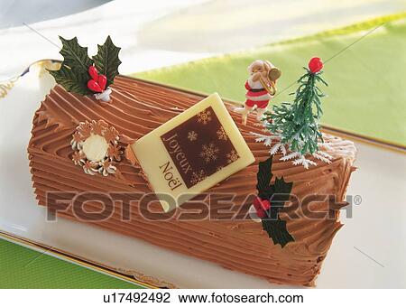 Stock Image - Christmas cake rolled up and covered with chocolate cream, Yolu log . Fotosearch