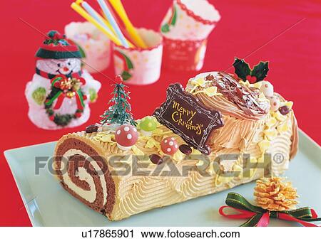 Stock Image - Christmas cake rolled up and covered with chocolate cream, Yolu log . Fotosearch