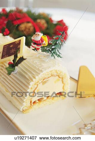 Stock Photo - Christmas cake rolled up and covered with cream, Yolu log . Fotosearch