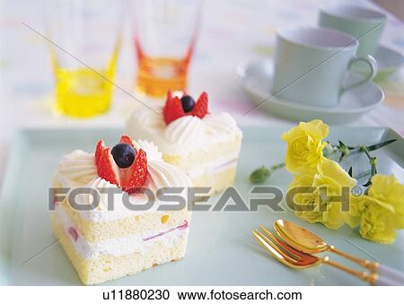 Stock Image - Slices of strawberry cake with whipped cream. Fotosearch