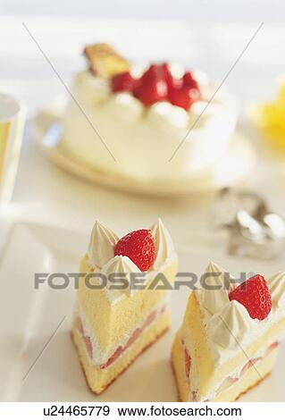 Stock Photo - Slices of strawberry cake with whipped cream. Fotosearch