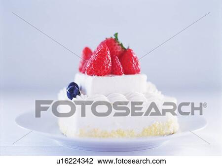 Stock Image - Small strawberry cake with whipped cream on plate. Fotosearch