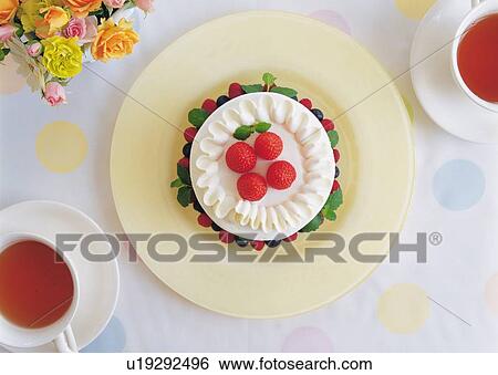 Strawberry cake and cups of tea on table View Large Photo Image Stock Photograph - Strawberry cake and cups of tea on table. Fotosearch