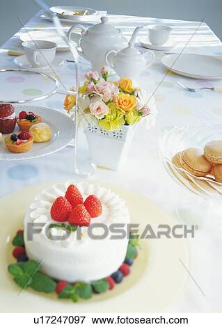 Strawberry cake and dishes on dining table View Large Photo Image Stock Photo - Strawberry cake and dishes on dining table. Fotosearch