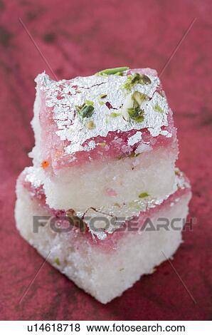 Close-up of a stack of Burfi garnished with Pistachio View Large Photo Image Stock Photo - Close-up of a stack of Burfi garnished with Pistachio. Fotosearch